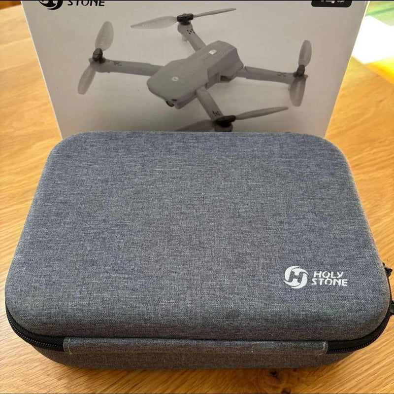 Gray hard-shell drone carrying case with zipper and Holy Stone logo patch