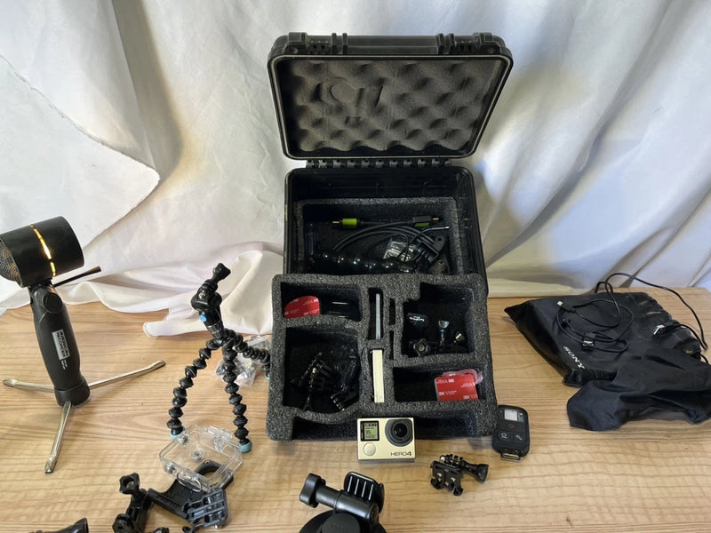 GoPro action camera accessory kit in hard case with mounts, cables, and camera