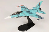F-16B model jet with turquoise camouflage on black display stand