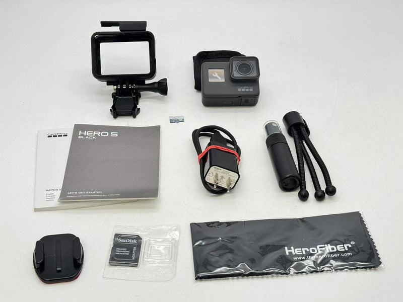 Black action camera kit with case mount, battery, cables, and Hero5 accessories