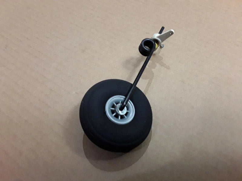 RC airplane landing gear wheel with black tire and metal axle fork
