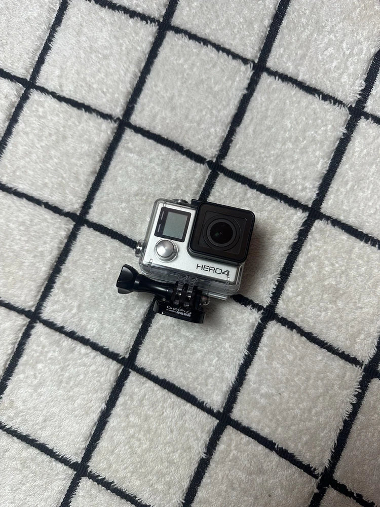 GoPro HERO4 Silver action camera in black waterproof housing, front display and lens visible