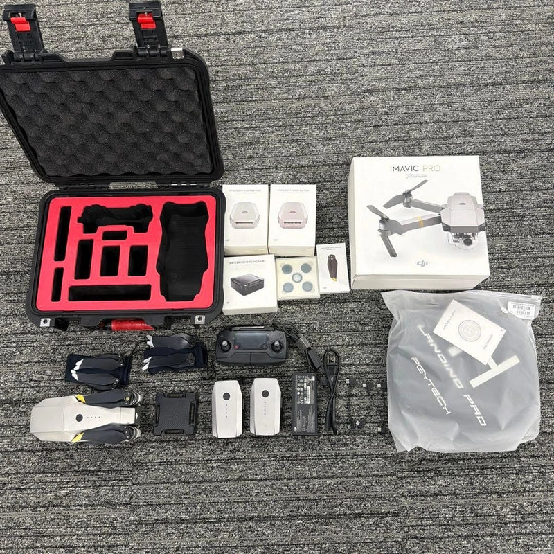 Drone accessories lot in black hard case with foam insert, small parts and manuals