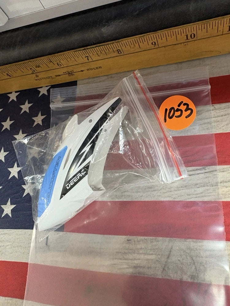 Helicopter canopy shell in blue, white, and black with protective plastic wrap