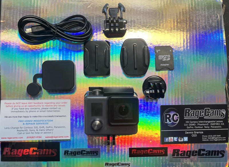 Grey action camera kit with helmet mount, housing, and microSD card accessory