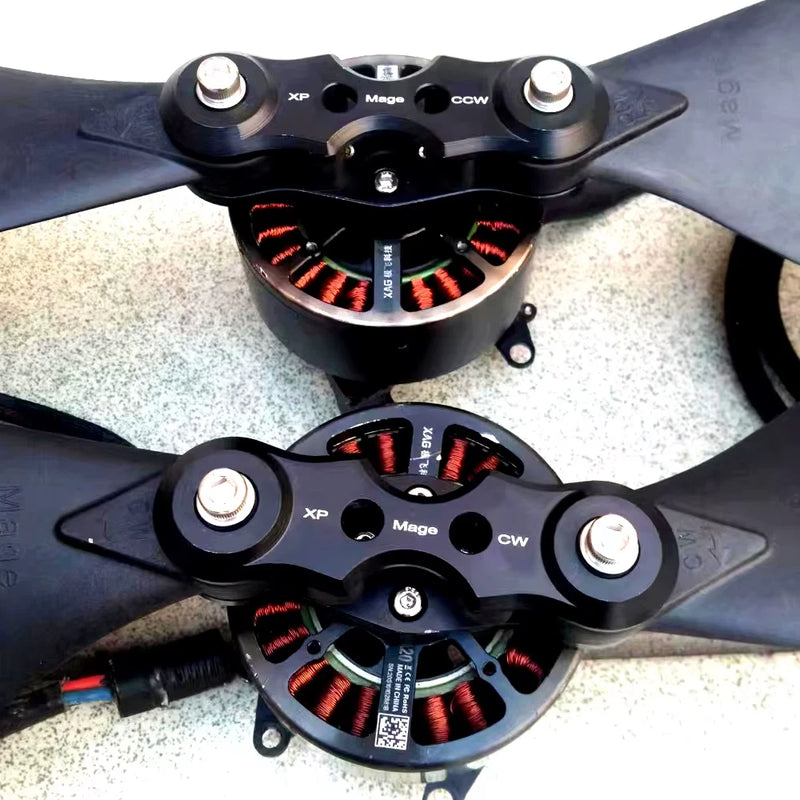 Black brushless drone motor pair with circular stators, mounting screws, wiring