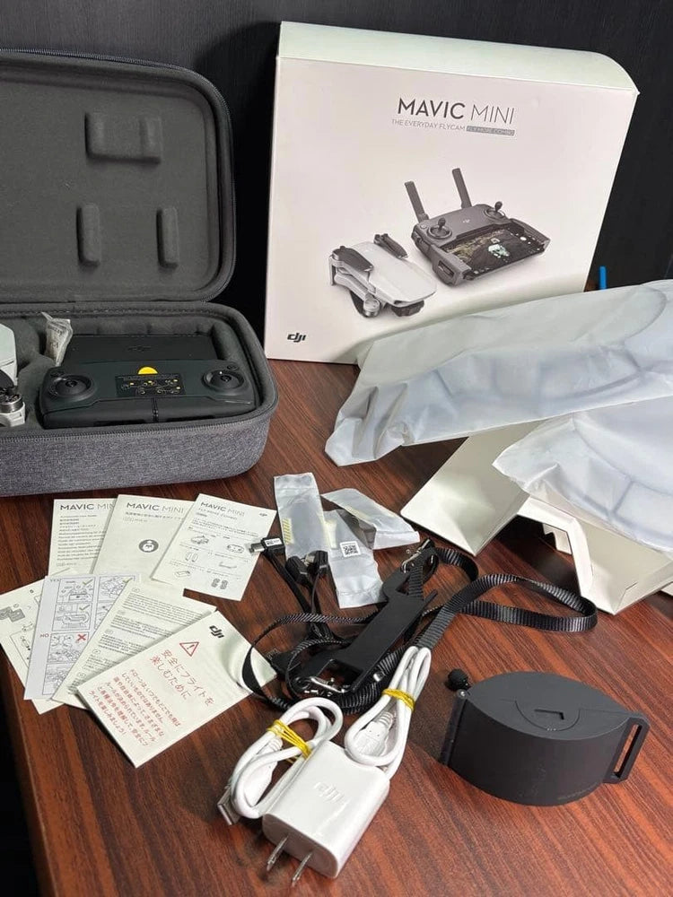 DJI Mavic Mini drone kit with remote, spare battery, cables, manuals, and case