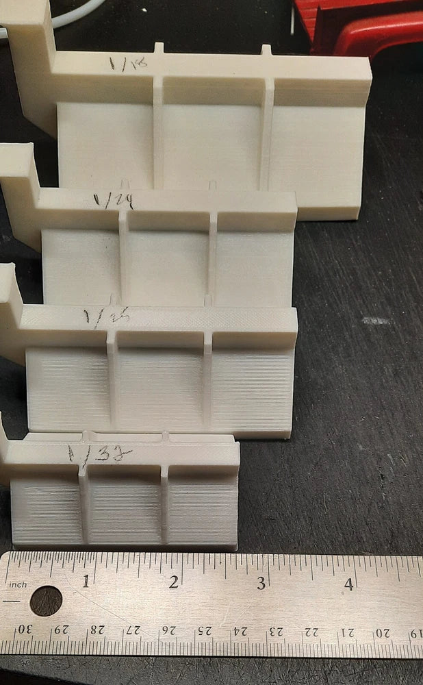 White plastic scale model sand spreader parts with multiple rectangular compartments