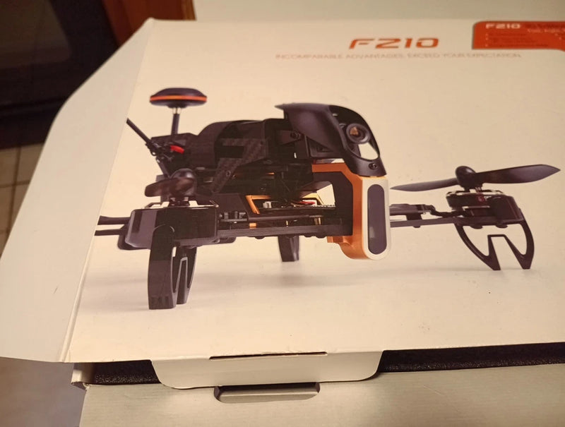 Black quadcopter racing drone with 4 propellers, side view