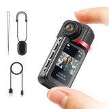 Handheld thumb action camera with LCD screen, USB cables and strap lanyard