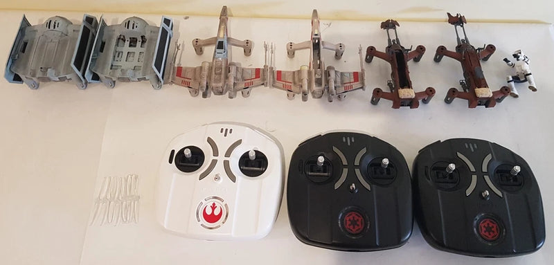 Drone remote controllers set: one white and two black units with buttons and antennas