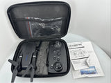 Folding drone in open black protective case with remote controller and instruction papers