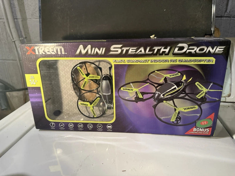 Mini stealth drone toy quadcopter in retail box with green propeller graphics