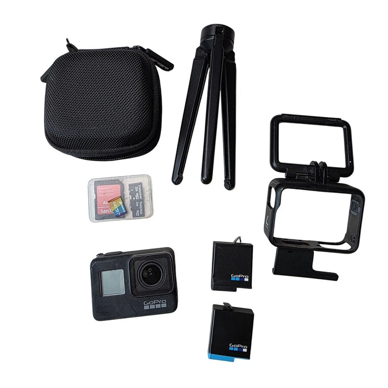 Black action camera bundle with tripod, protective case, battery, and SD cards