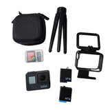 Black action camera bundle with tripod, protective case, battery, and SD cards