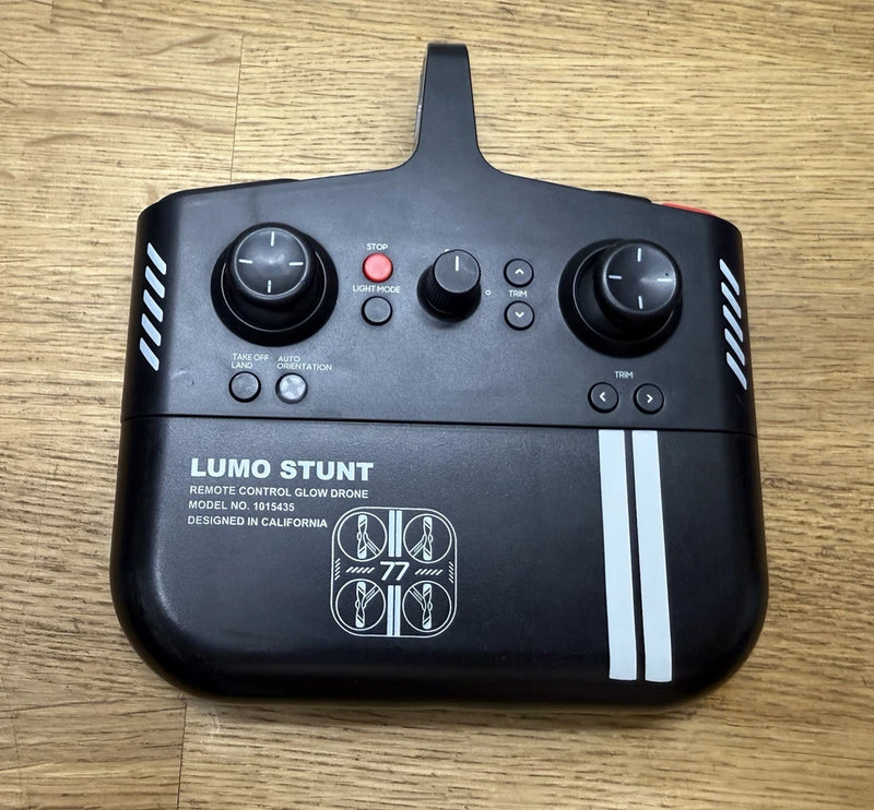 Black remote controller with joysticks and buttons for LED glow drone