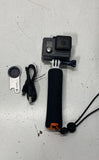 GoPro action camera with waterproof housing, foam grip handle, and charging cable