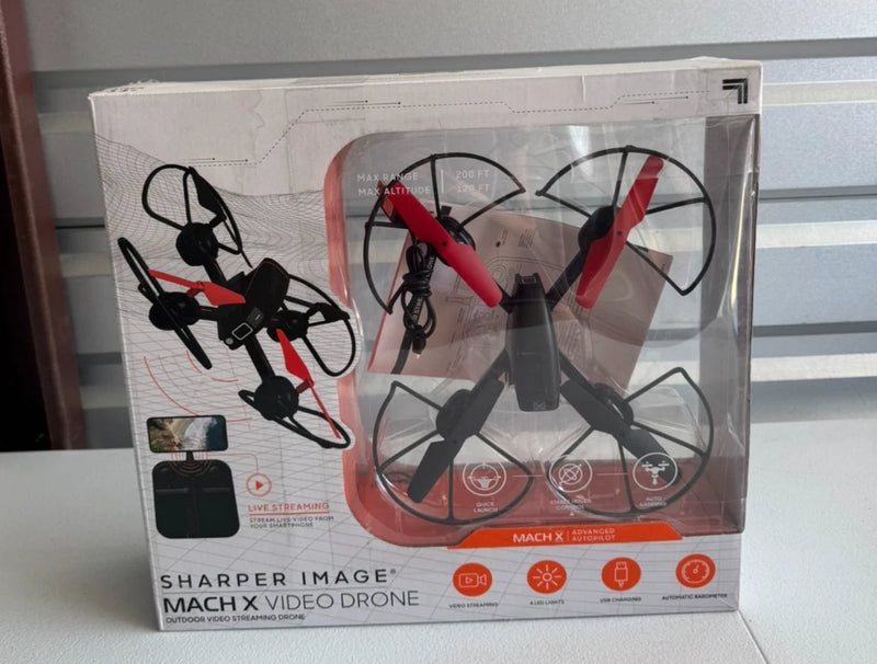 Boxed RC quadcopter drone with camera, black and red, visible propellers