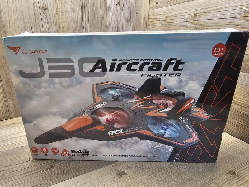 RC fighter jet airplane toy on sealed retail box, orange and gray design