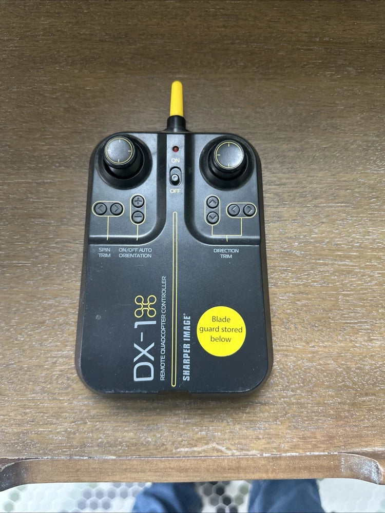 Black handheld micro drone controller with yellow antenna, buttons and control sticks