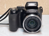 Black FUJIFILM FinePix S5700 digital camera with attached lens and hand grip