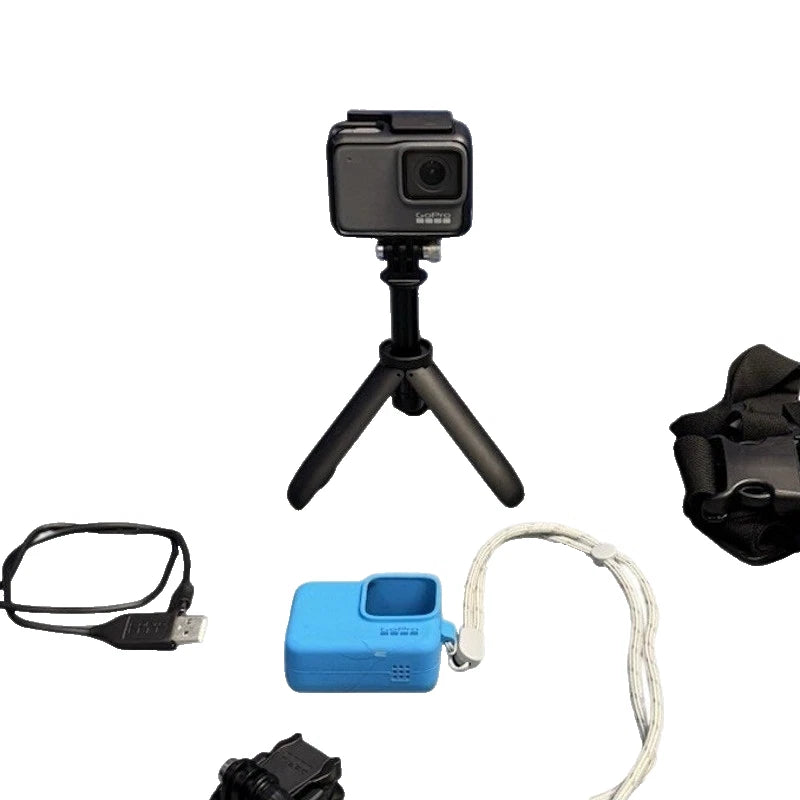 GoPro HERO7 action camera kit with mini tripod, blue case, cables, and mounts