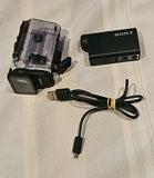 Sony action camera with clear underwater housing, battery and USB cable