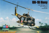 Camouflage UH-1B Huey helicopter model with open skids and spinning rotor