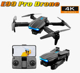 Quadcopter drone with dark body, four propellers, and blue status lights; remote controller