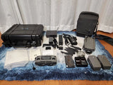 Drone accessory kit with hard case, batteries, charging hub, cables, and remote parts