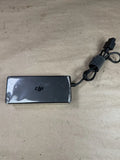 DJI battery charger with black rectangular housing and attached power cable