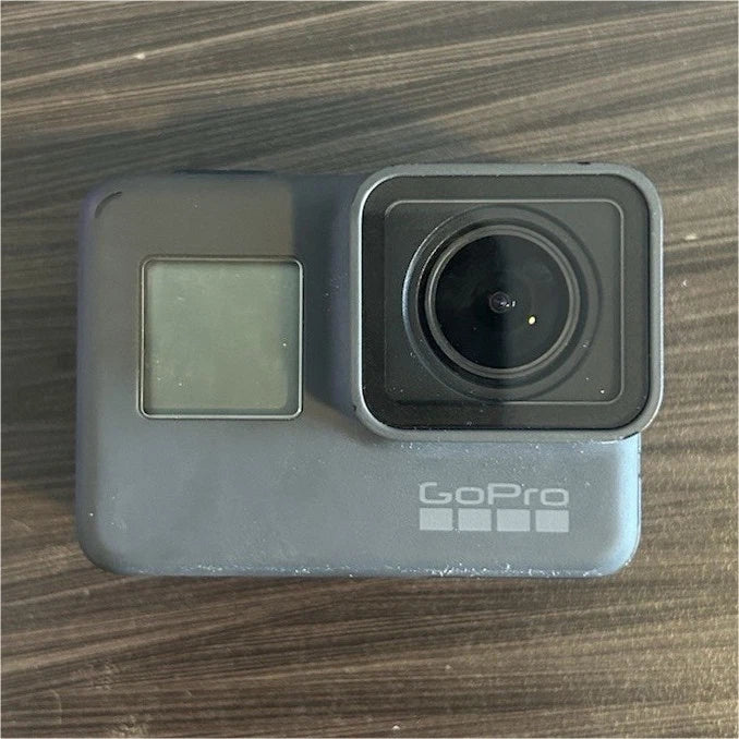 GoPro action camera with front lens and touchscreen window, gray/black body