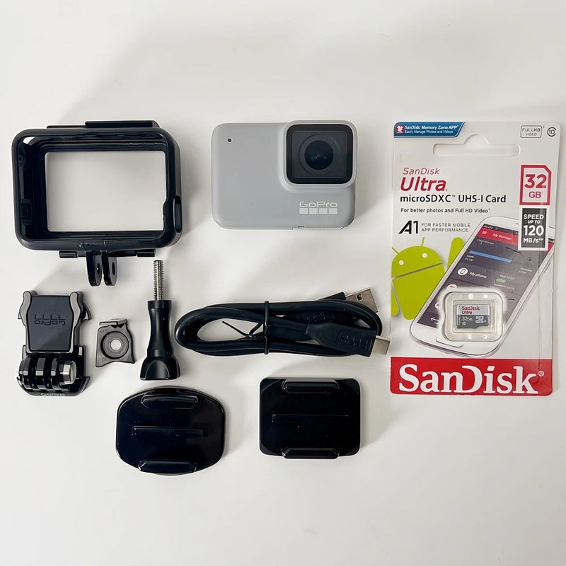 White waterproof action camera with mounts, housing, cable, and lens covers