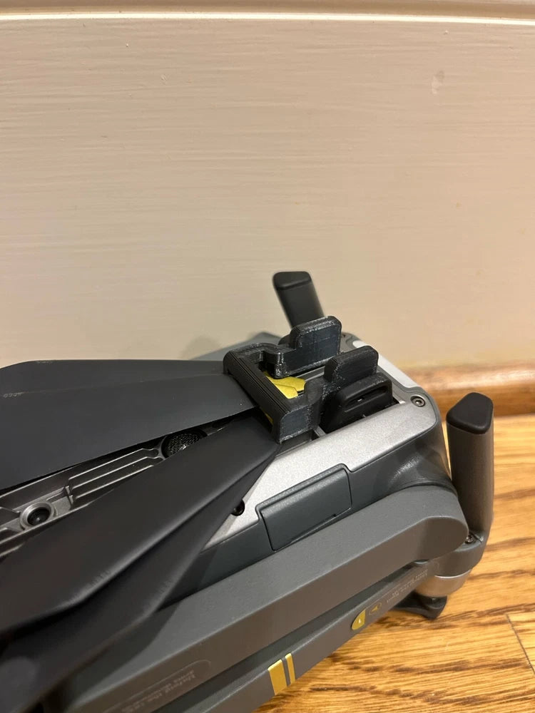 DJI Mavic Pro propeller lock on gray drone arm with black propeller blades