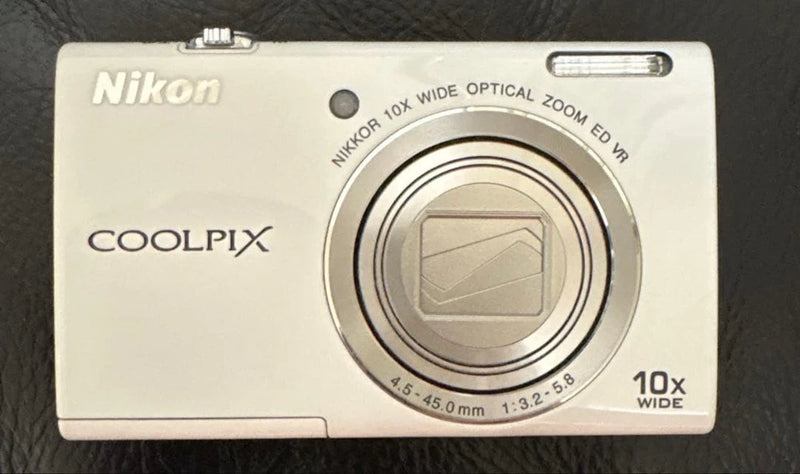 Nikon COOLPIX compact digital camera front with zoom lens, Nikon logo