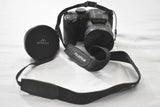 Black Fujifilm FinePix S4800 digital camera with lens cap and carrying strap