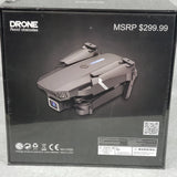 Foldable gray quadcopter drone with camera, retail packaging