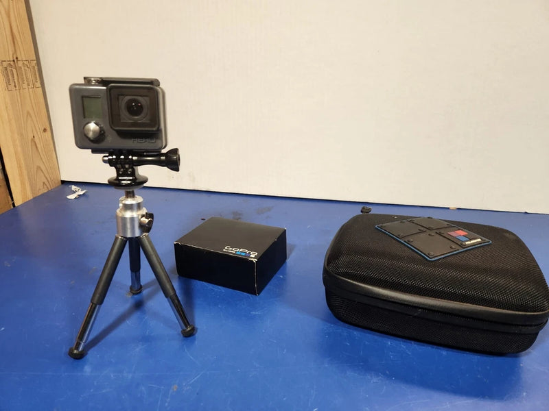 GoPro Hero Original HD action camera on tripod with protective carrying case