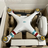 White quadcopter drone with four propellers and camera body in a shipping box