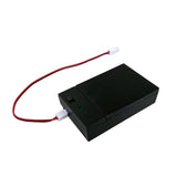 Black battery box with red wire leads and two white connectors