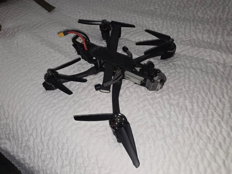 DJI FPV freestyle quadcopter drone, black frame with front camera and four arms