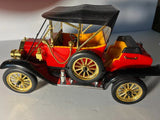 Battery-powered vintage red and black toy car with gold wheels and open cabin
