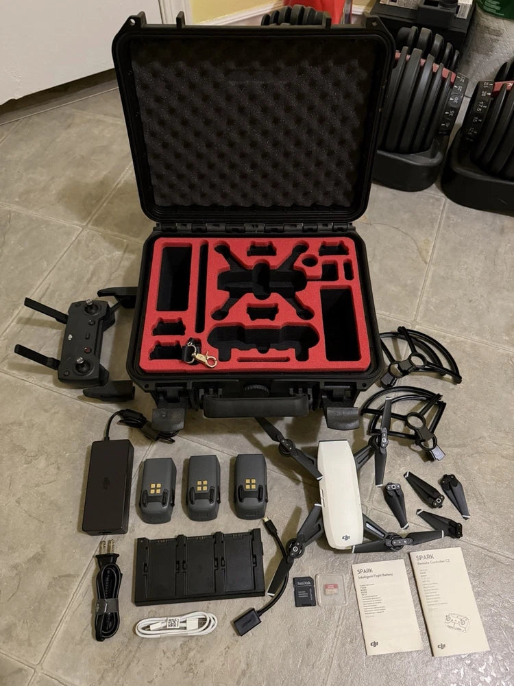 Open hard case with quadcopter drone, batteries, propellers, and cables