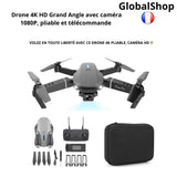 Foldable gray quadcopter drone with front camera, remote controller and carrying case