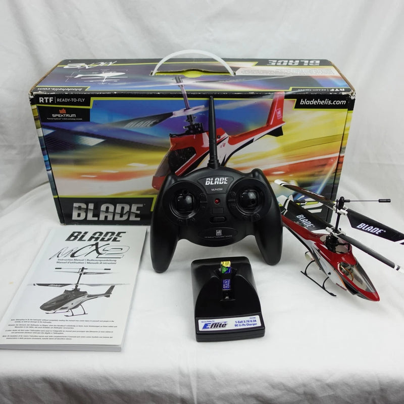 RC helicopter set with black remote controller, battery, charger, and model