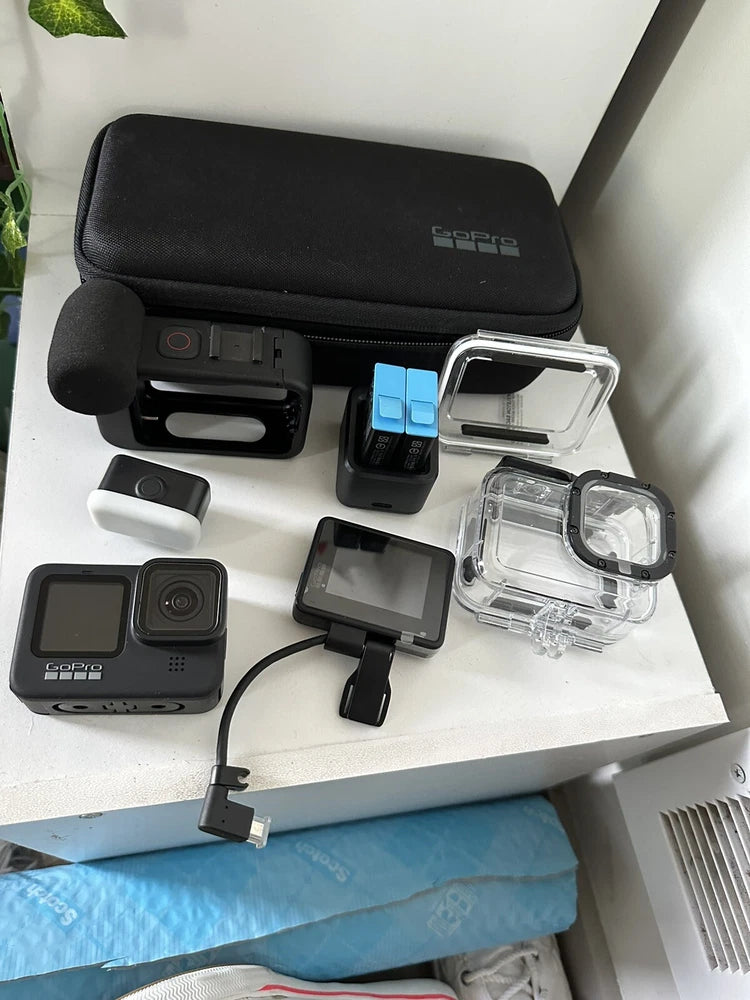 GoPro HERO9 Black action camera with mounts, protective housing, and battery accessories