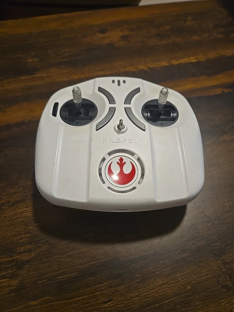 White RC drone remote controller with two joysticks and red circular emblem