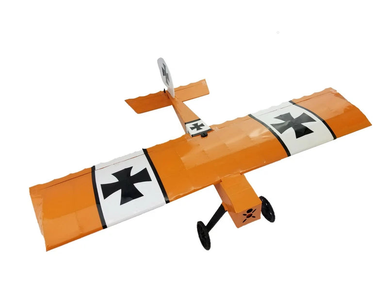 Orange and white RC airplane model kit with black cross markings and propeller