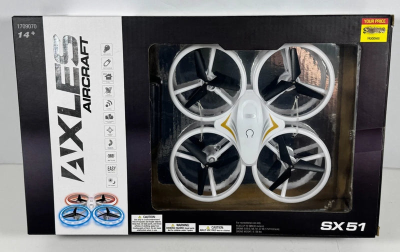 LED RC quadcopter drone with four white propellers in retail box window