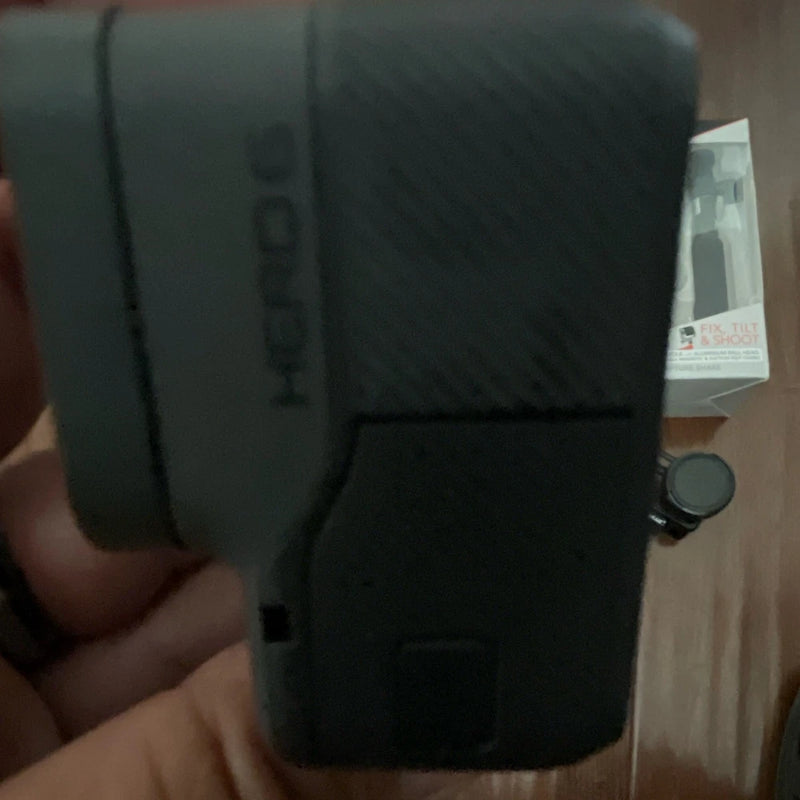 Black GoPro HERO6 action camera with rugged case and wrist strap
